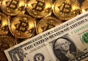 FILE PHOTO: Illustration shows representations of cryptocurrency Bitcoin and U.S. dollar